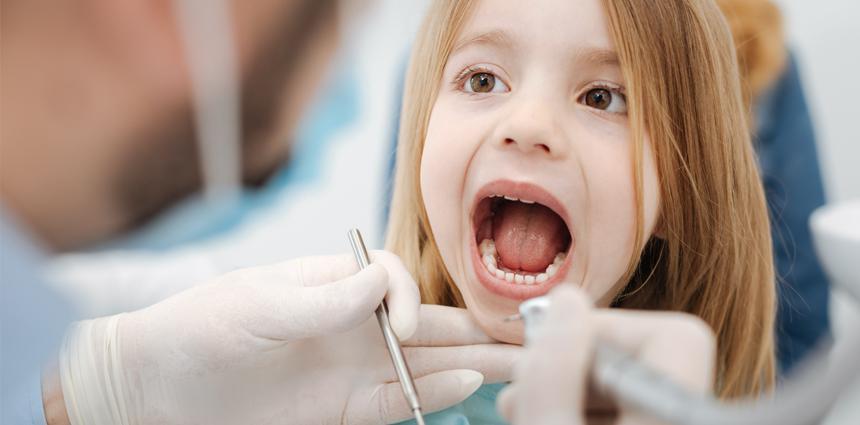 small girl teeth cheking